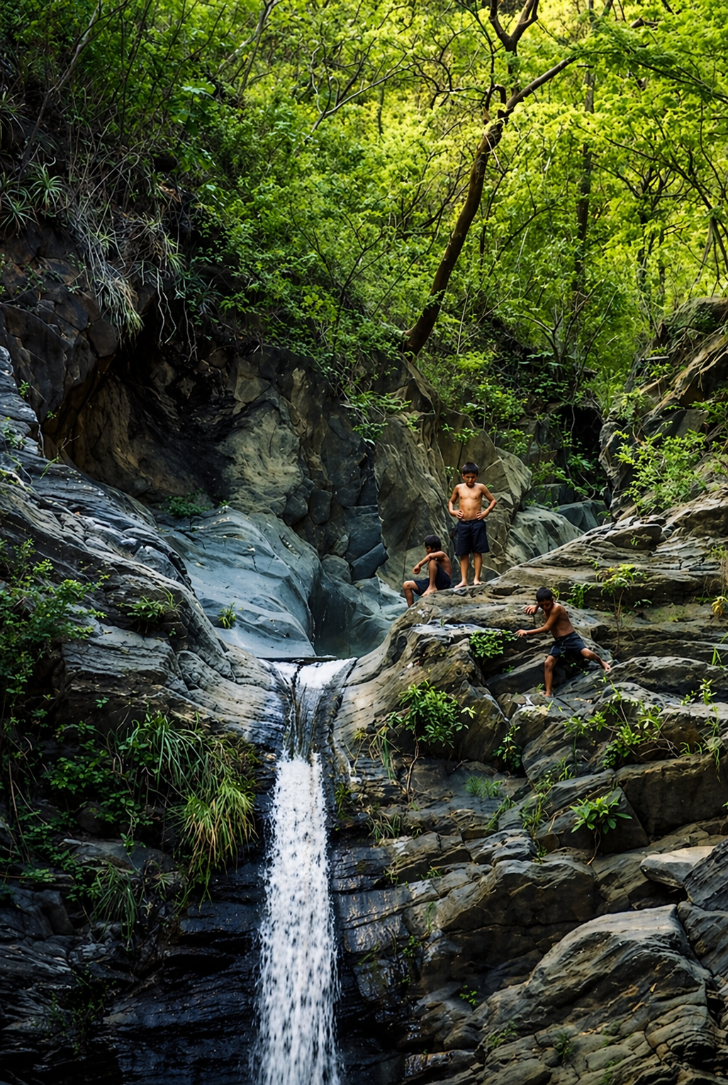 Local boys waterfall jumping in a jungle in Guatemala