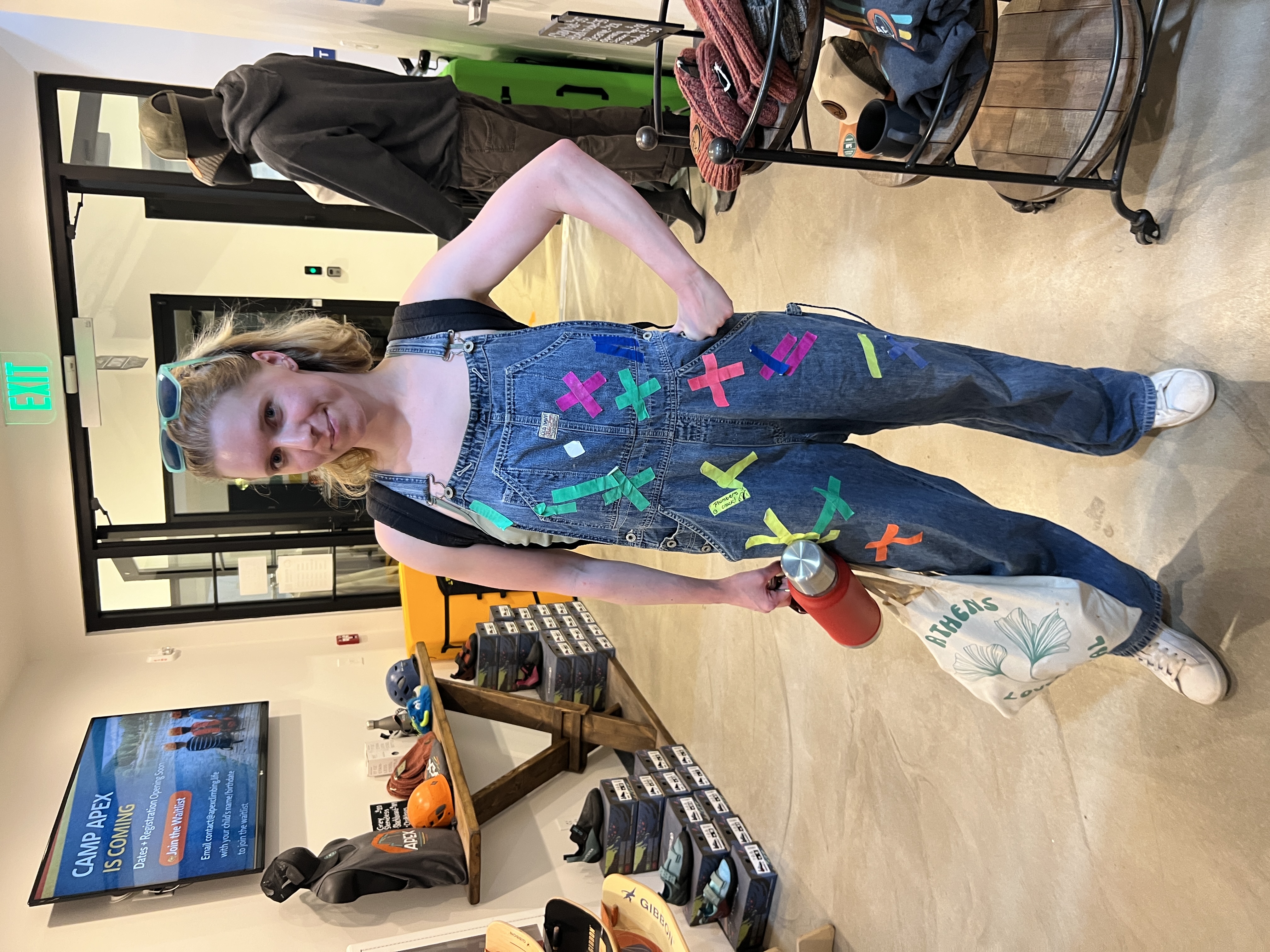 Camper with colorful tape on overalls