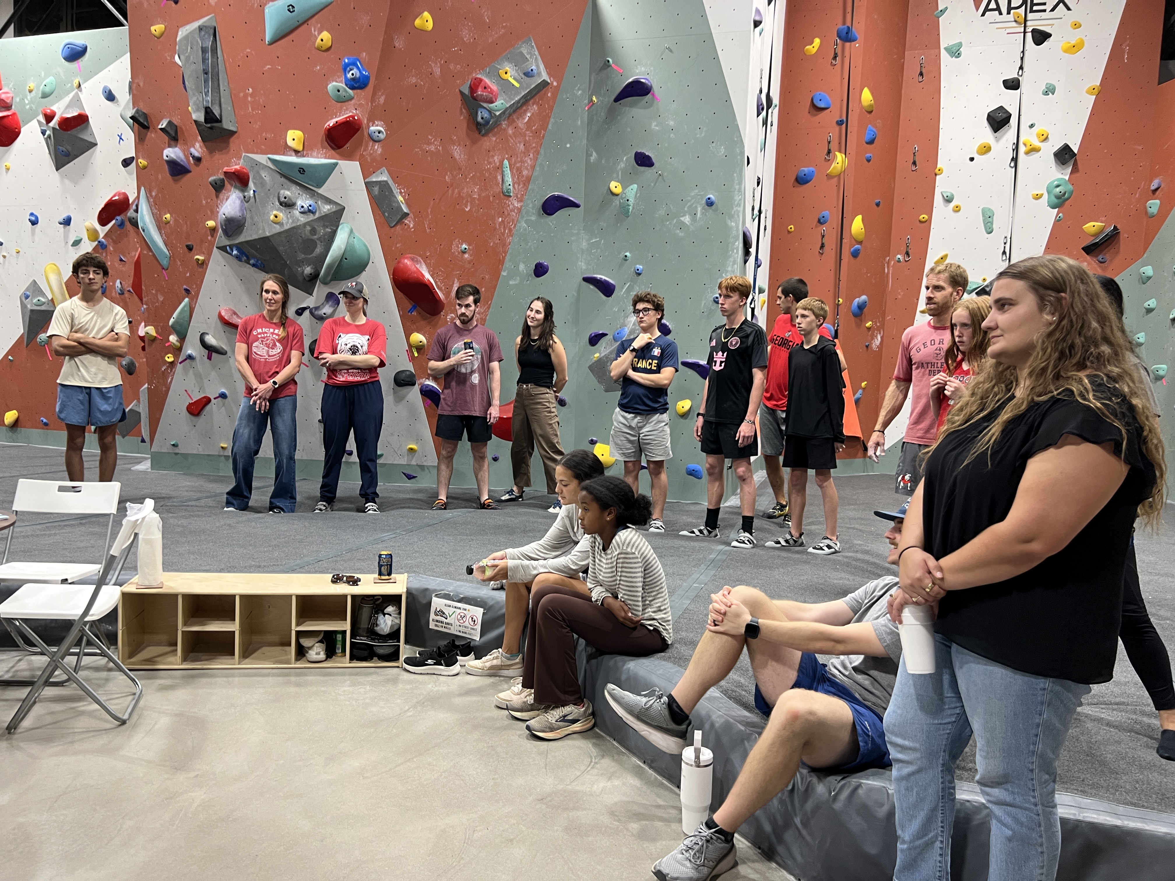 Climbers and spectators gathered together in the gym during the Bouldering Baristas throwdown at APEX